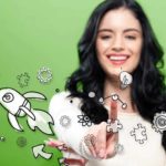 A woman on a green background points a finger at graphic images of molecules, a rocket, light bulbs and scientific symbols as she smiles.