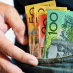 Australian dollar notes in the pocket of a man's jeans, symbolising dividends.